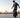 Beginner rider practicing on a black Kingsong 14D electric unicycle in a quiet training area