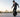 Beginner rider practicing balance on a KingSong electric unicycle in an open training area