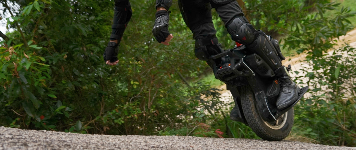 KingSong F16 rider cornering on dirt