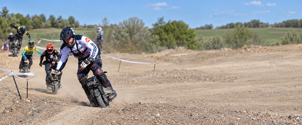 KingSong F18 riders racing on an off-road course